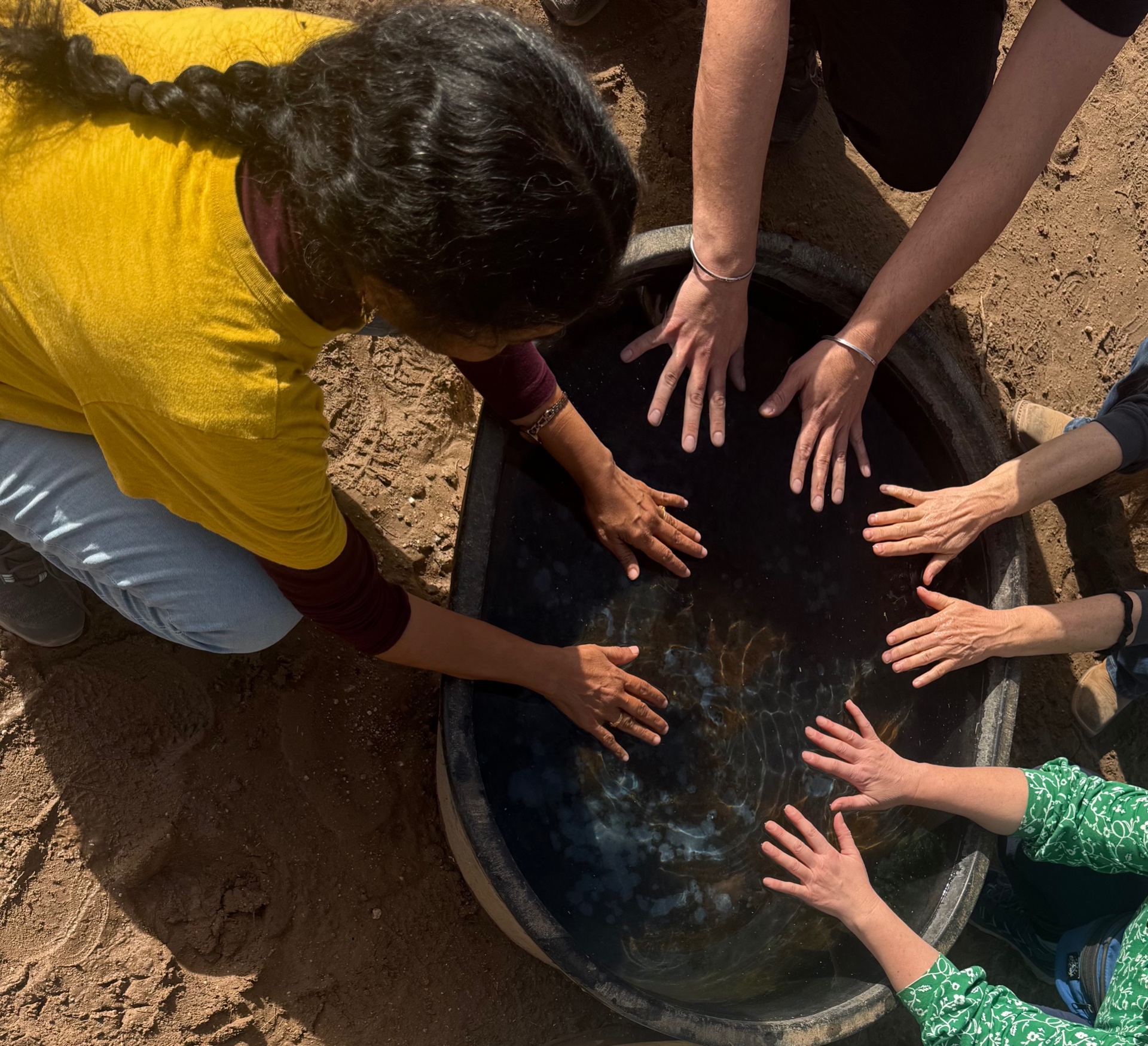 Community members connecting around water at Equinimity